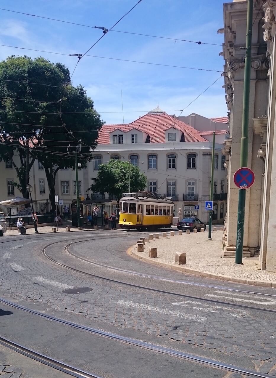 A yellow tram ascending in Lisbon