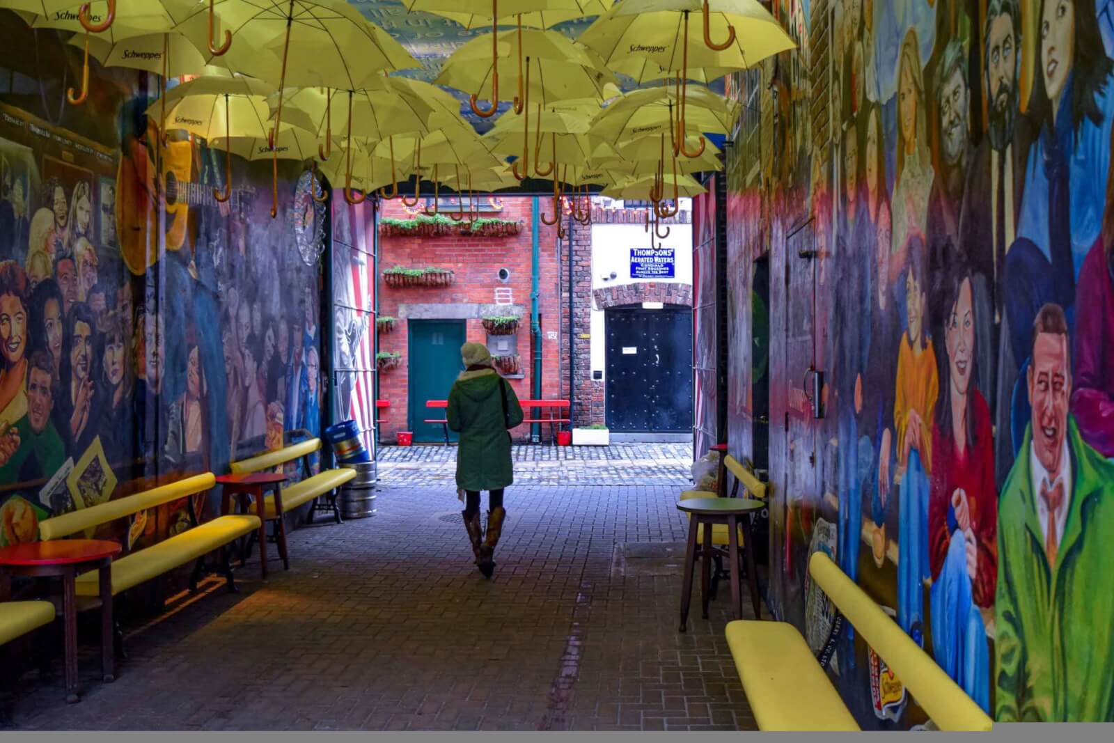 Hayley walking under yellow umbrellas in Belfast 
