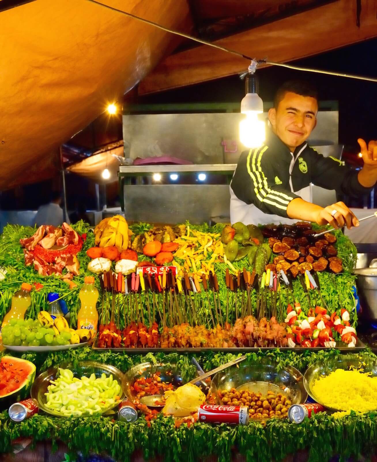 a friendly stall holder displaying his specialities 