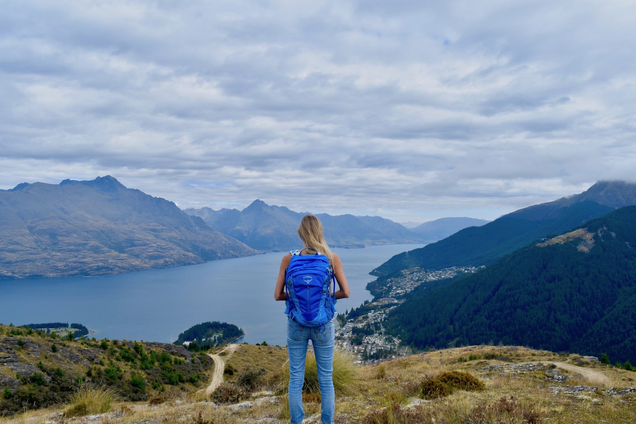 Hayley standing on a hill overlooking a lake 