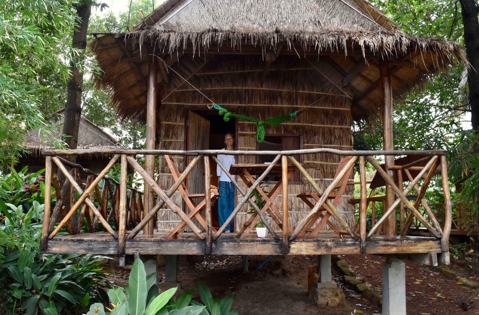 Hayley standing in front of a bamboo hut in Kampot