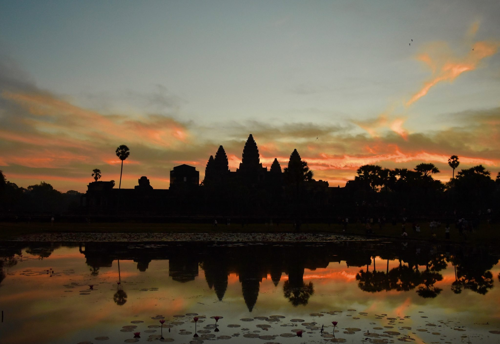 The sun rising behind Angkor Wat