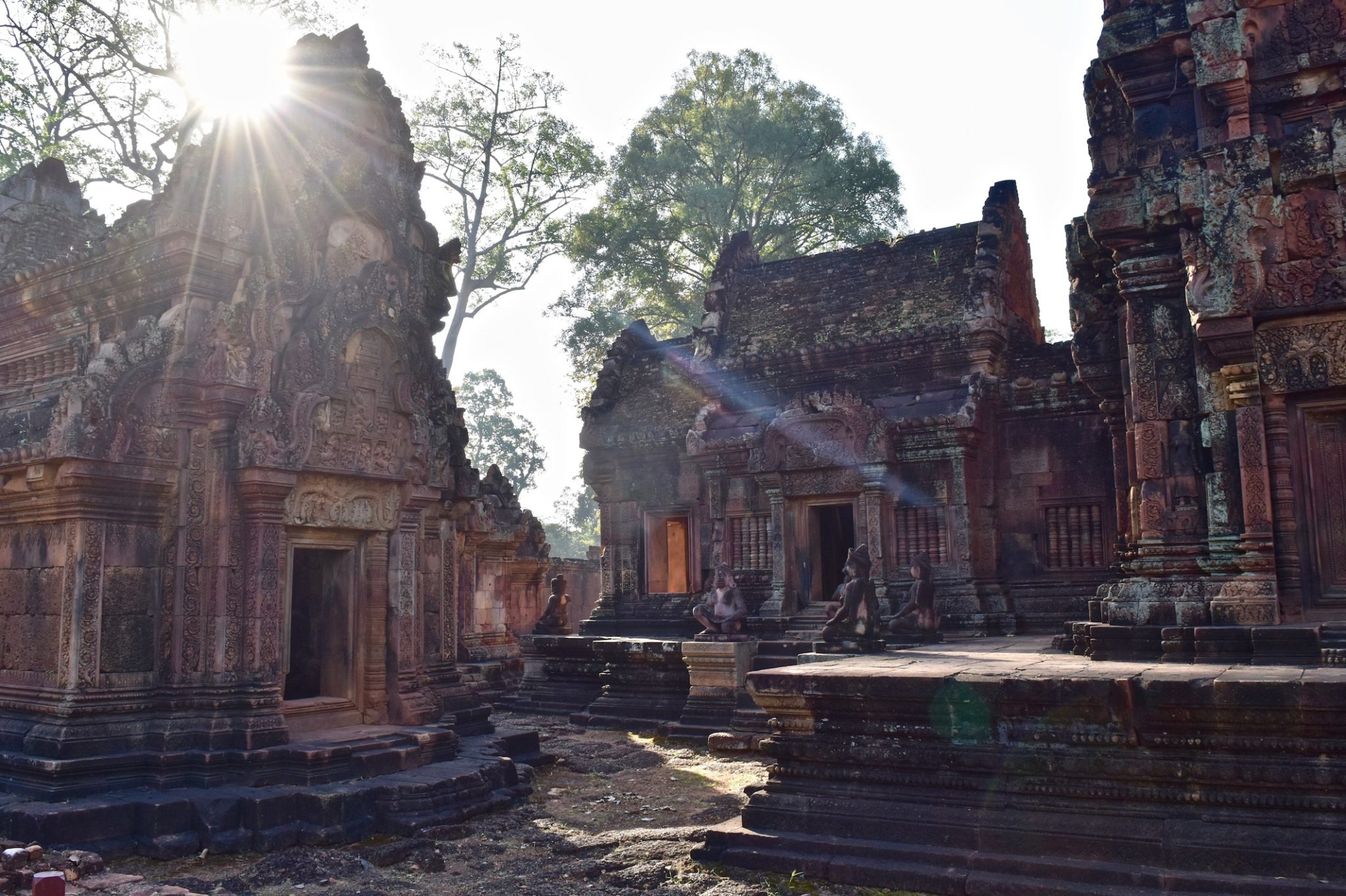 Detailed red sandstone carvings at Banteay Srei