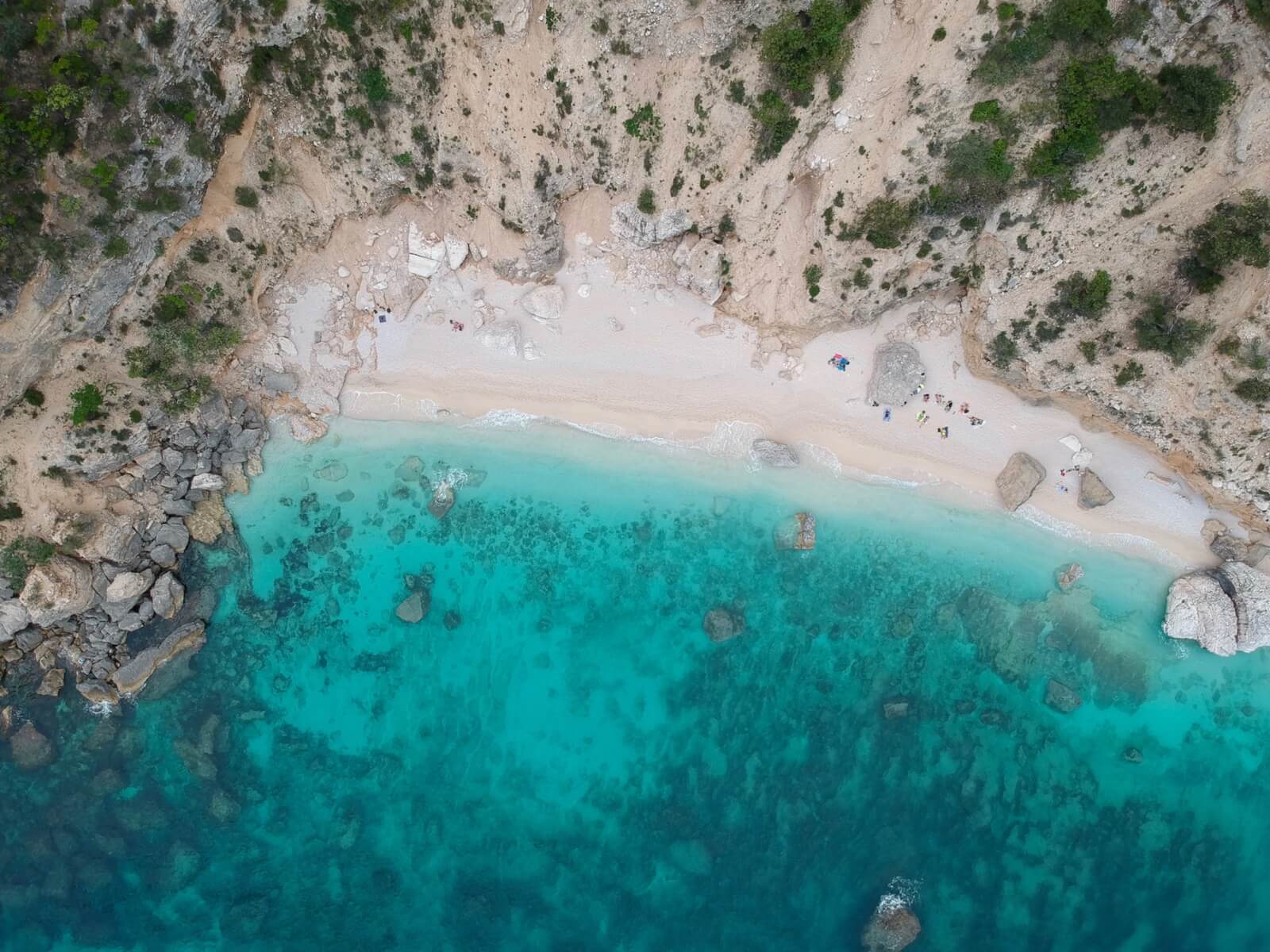 An aerial view of a white sand beach 