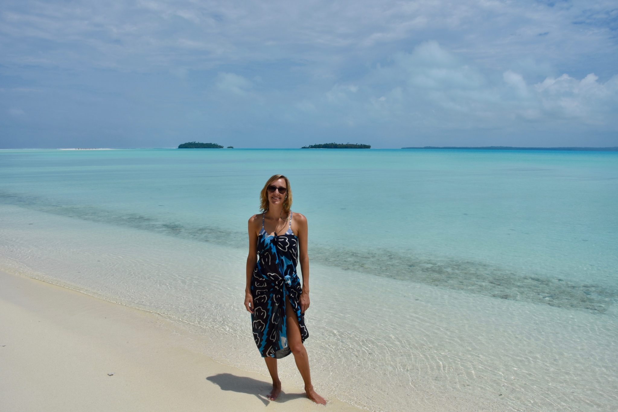 Hayley standing on a white sand beach in Aitutaki