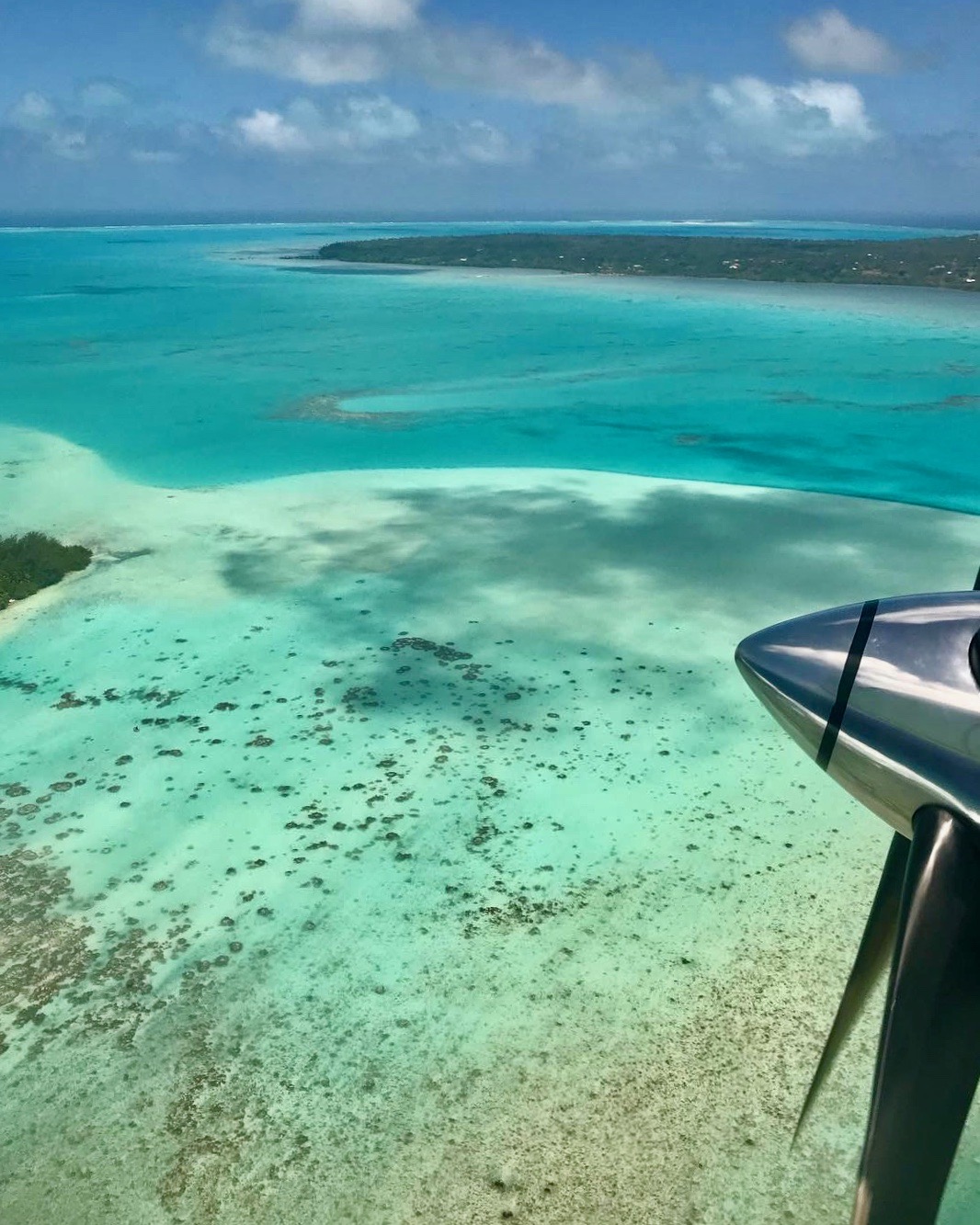 The view from a plane of a crystal clear blue lagoon