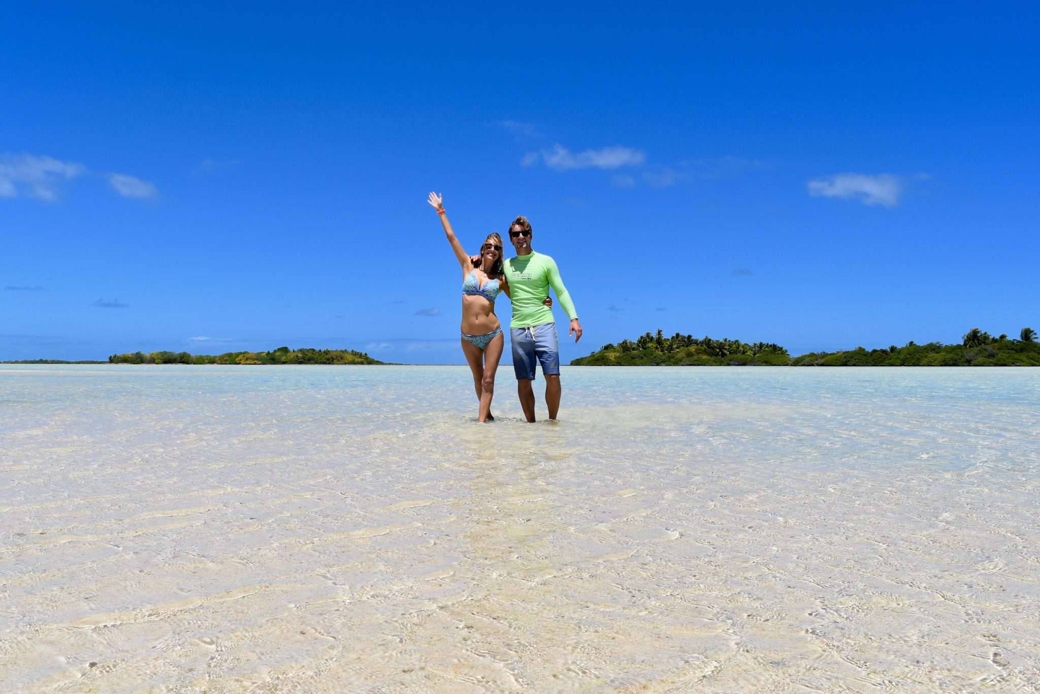 Hayley and Enrico standing in ankle deep water in the blue lagoon