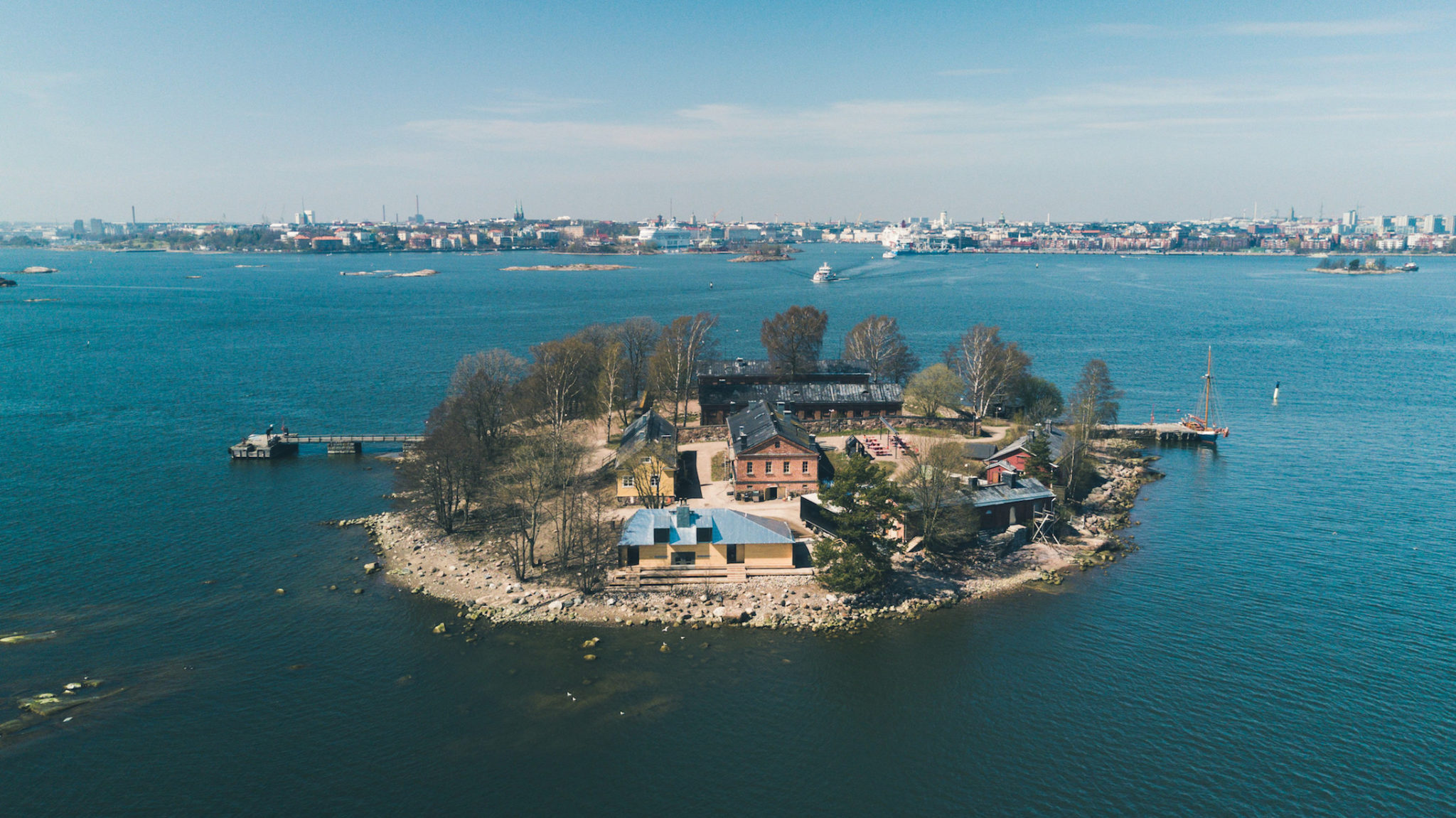 A small island with a number of buildings and trees, home to Lonna Sauna