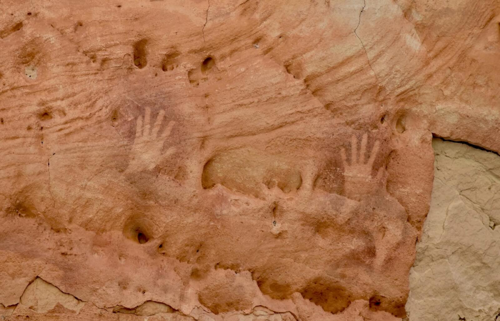 A print of a hand on a rock 