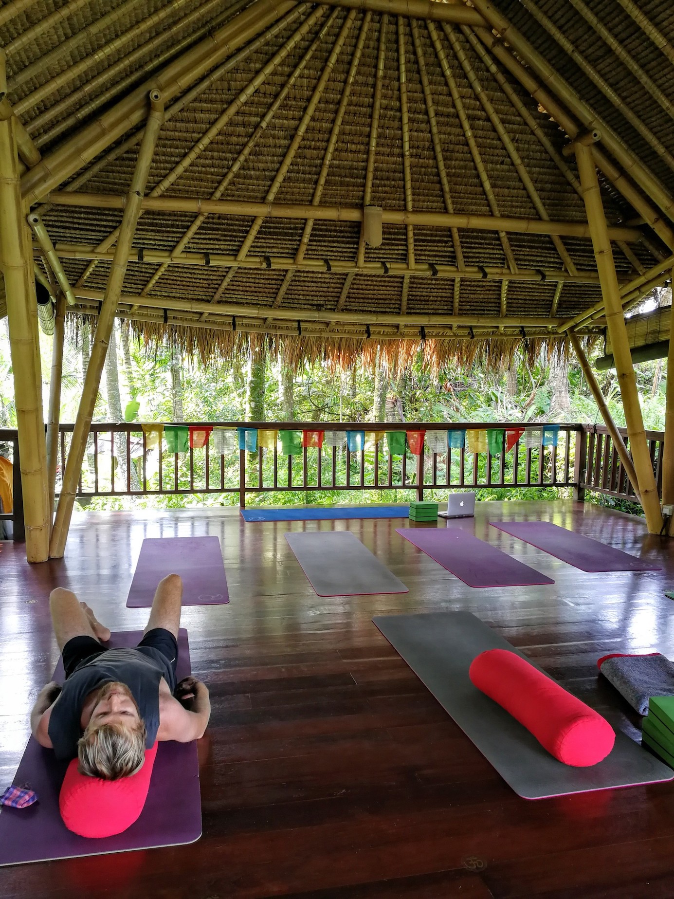 James laying on a yoga mat 