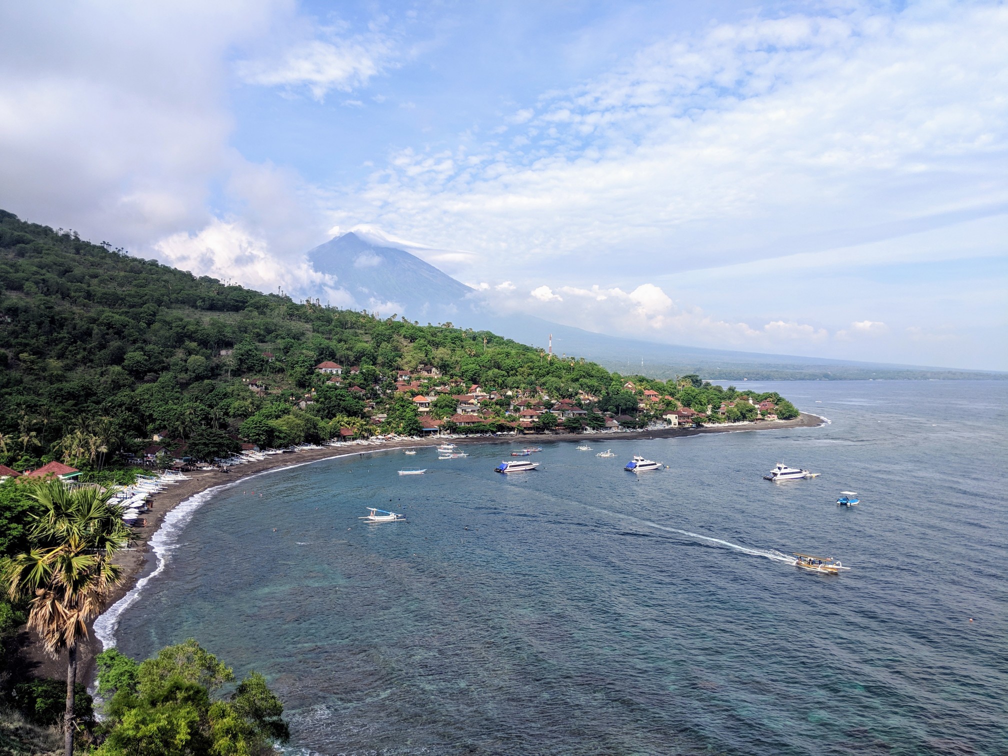 A scenic coastline picture with boats in the water 