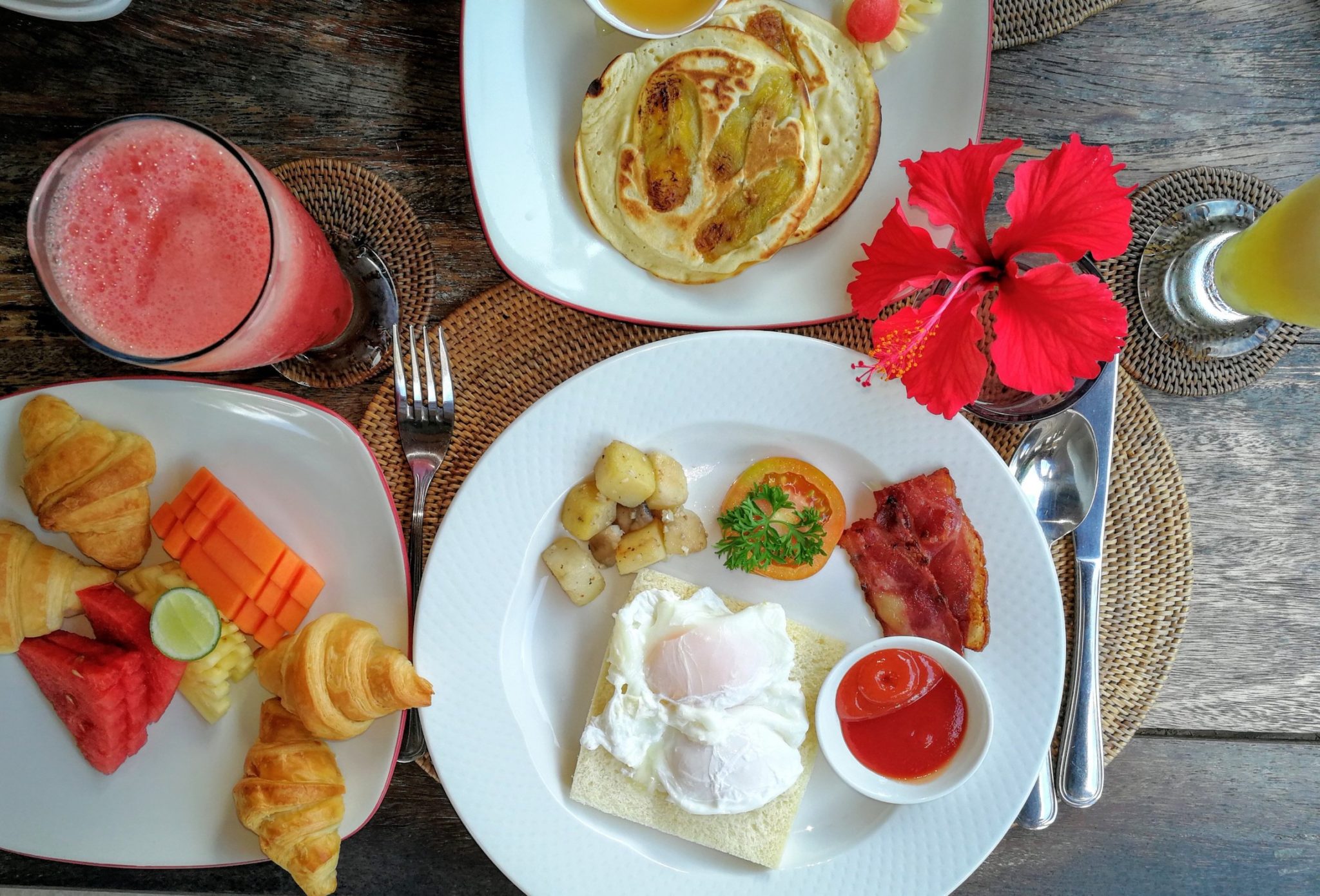 Breakfast of fresh fruit, pancakes and poached eggs 