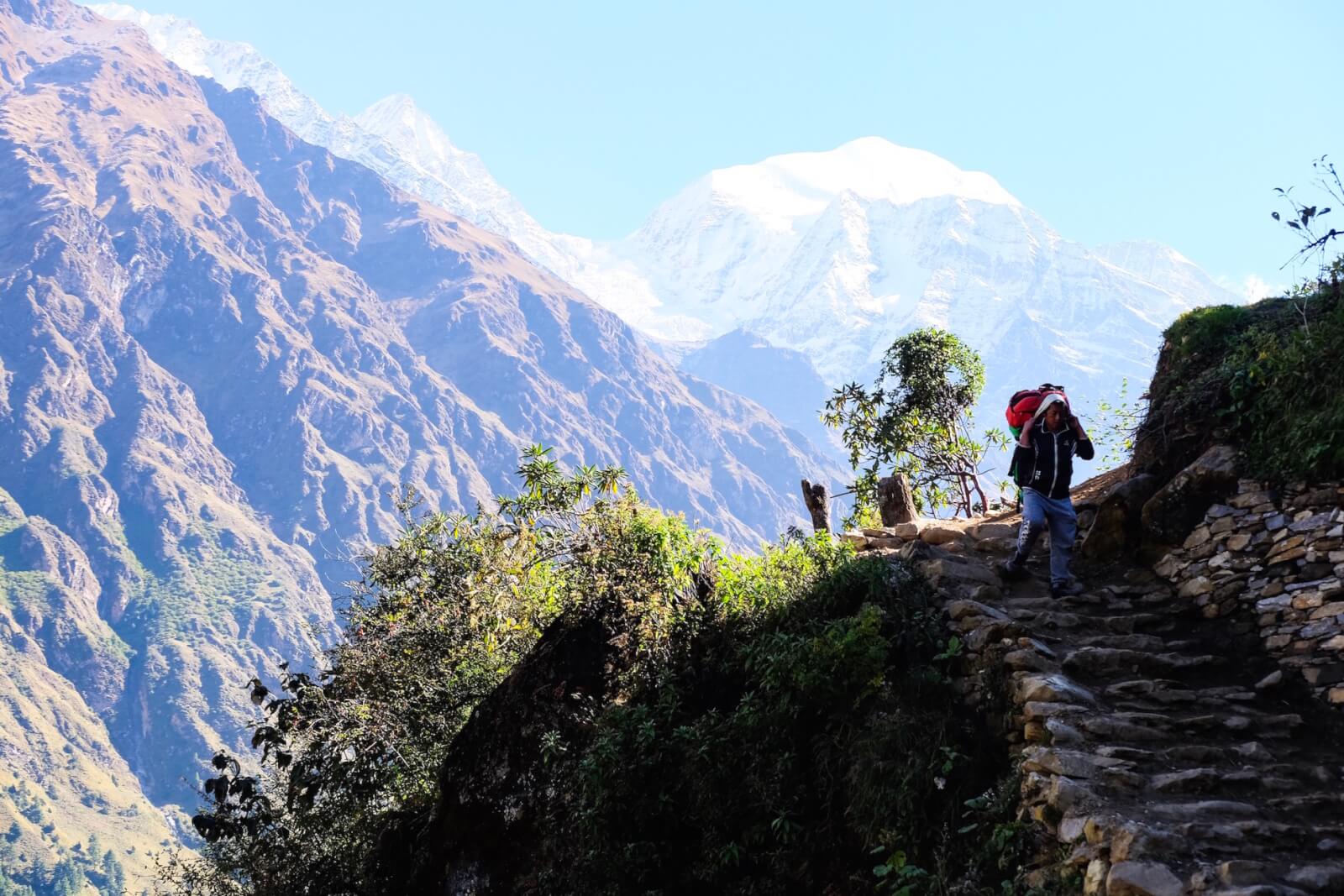 A porter carrying a 20kg pack in the mountains 