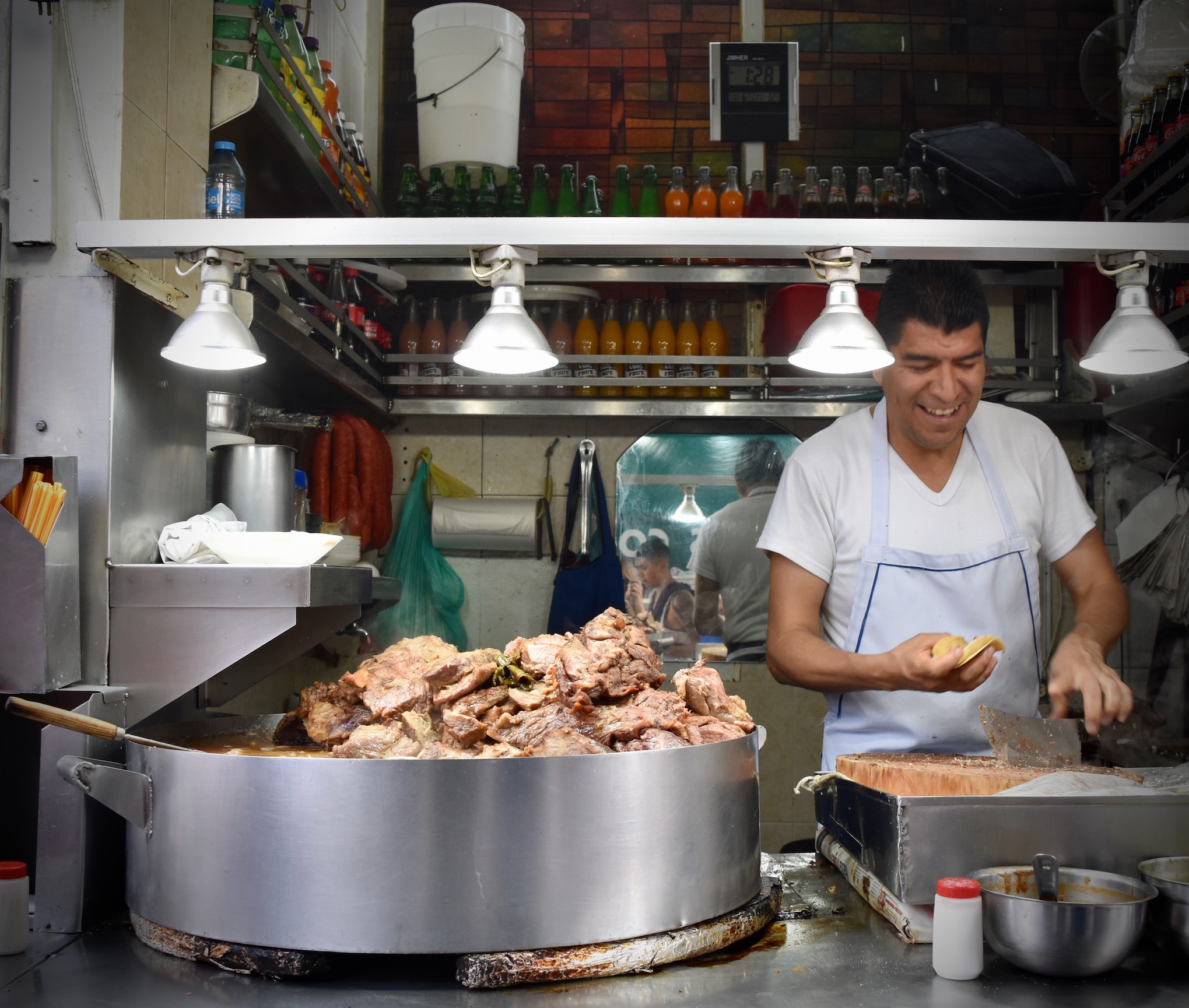 A large pot of meats cooking at Los Cocuyos