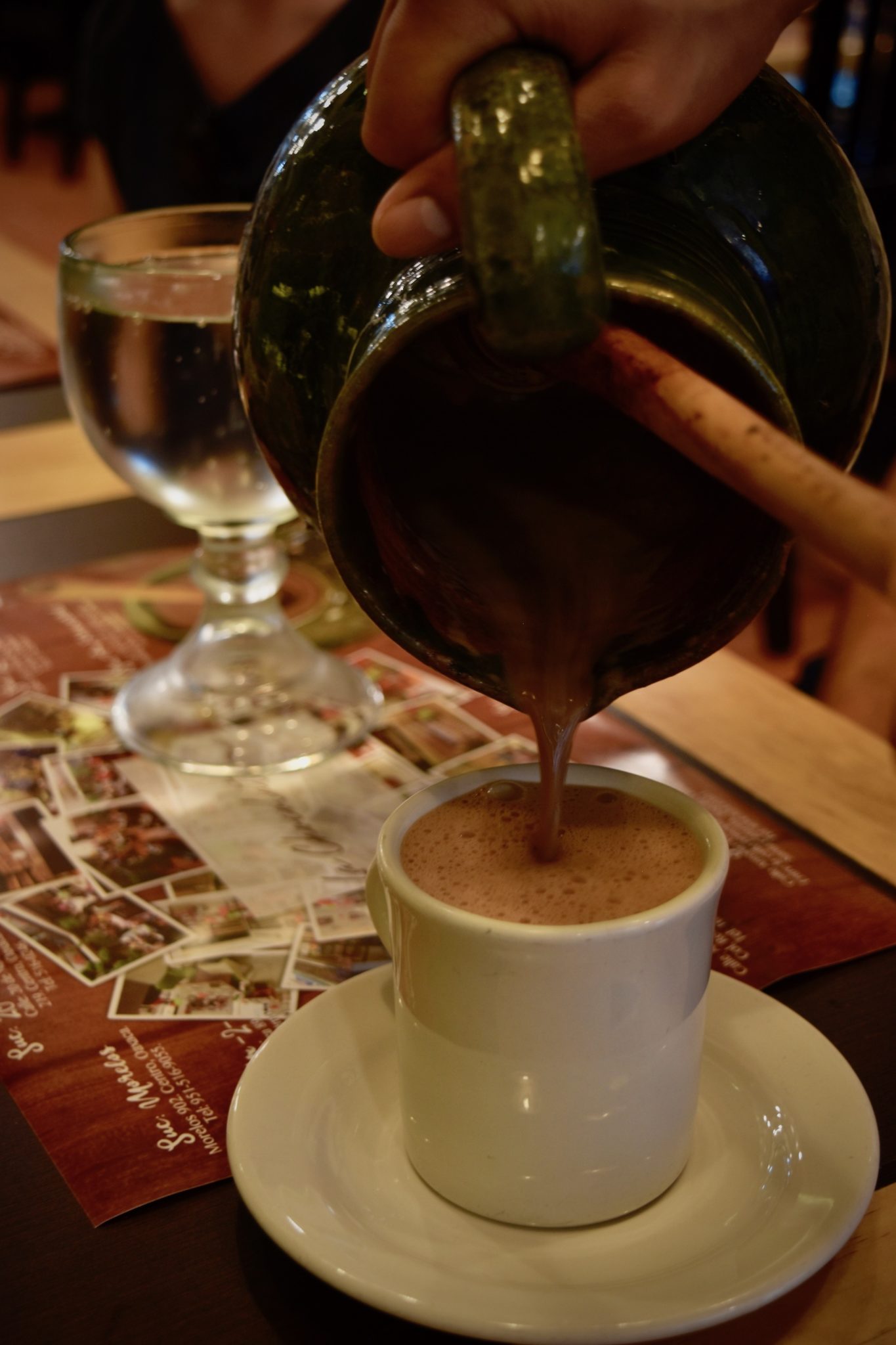 Hot chocolate being poured from a jug into a cup 