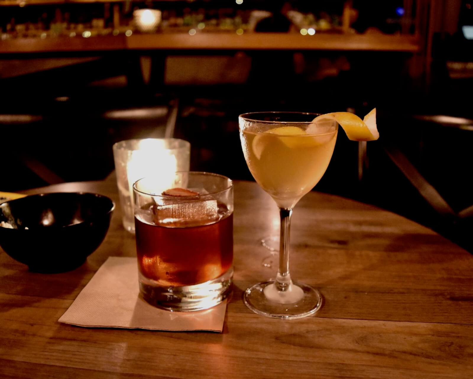 A martini cocktail and an old fashioned cocktail