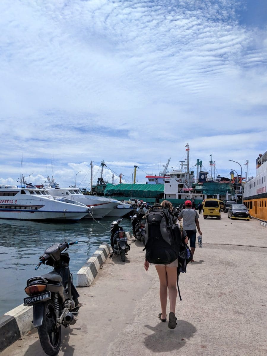 Sarah walking along the dock with her big backpack