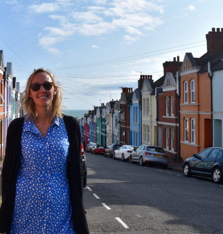 Hayley standing in front of the colourful houses on Blaker Street