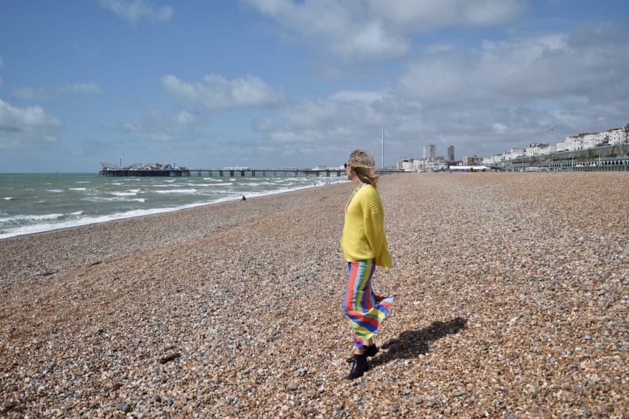 Hayley standing on the pebbles of Brighton Beach 