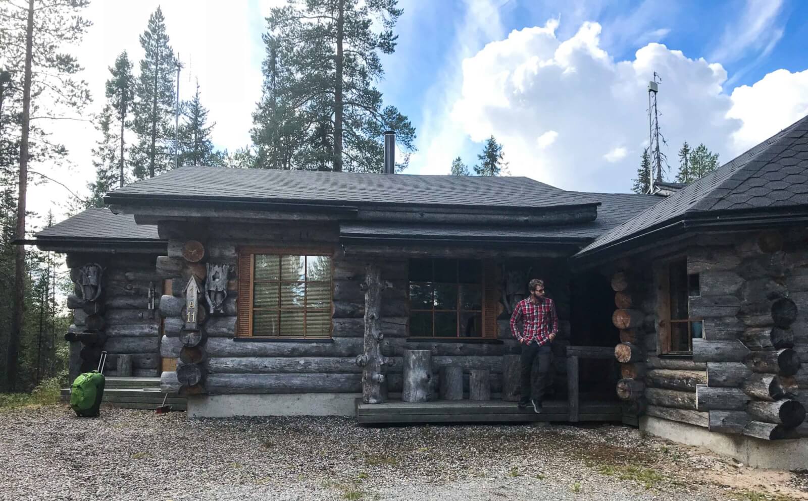 Enrico outside a log cabin in the Finnish countryside 