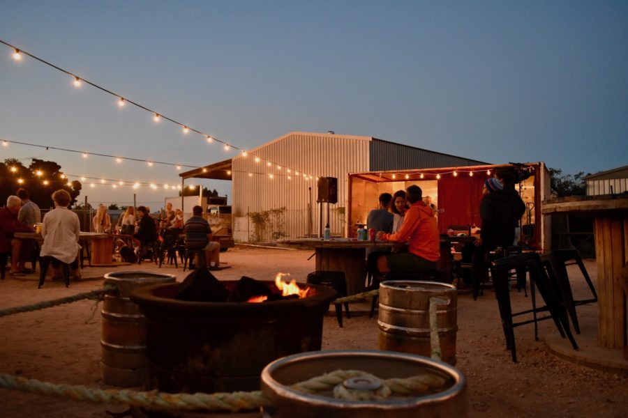 An outdoor bar with live music and a firepit 