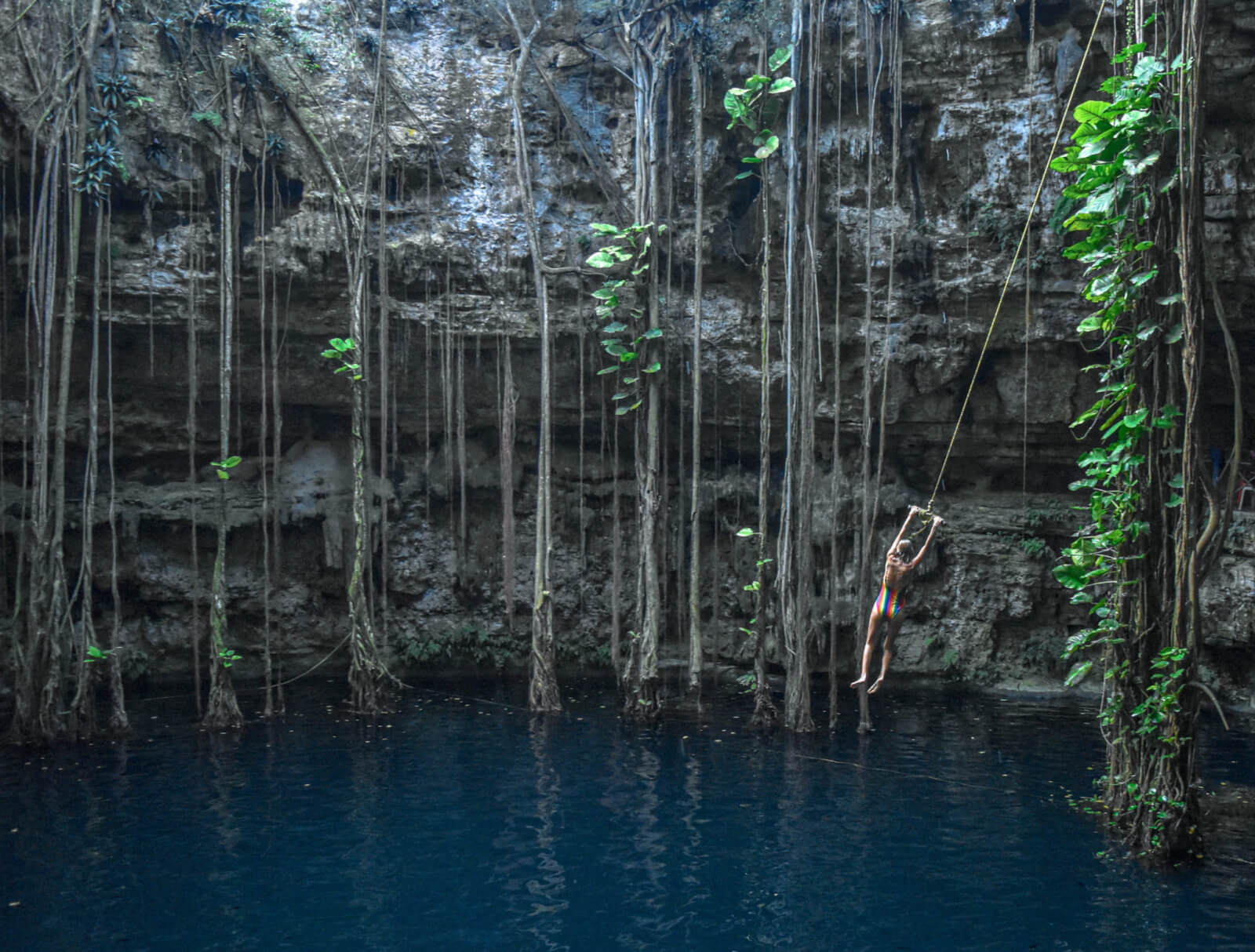 Rope swinging at Cenote Oxman
