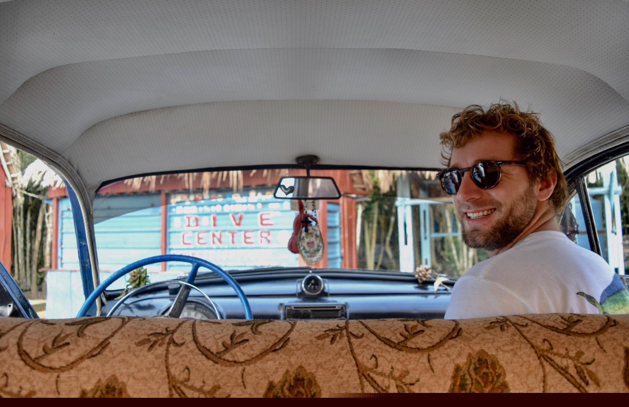 Enrico in the front seat of an old car 