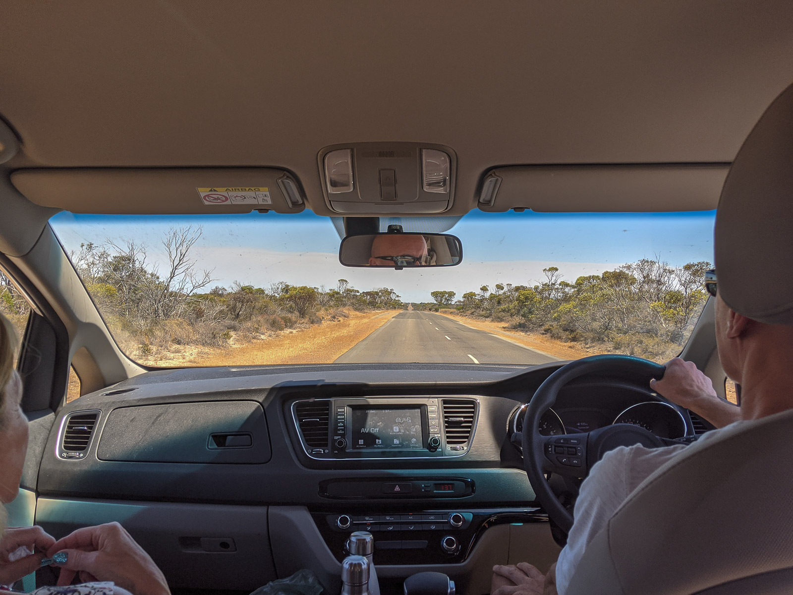 The view from the backseat of a car onto an empty WA road 