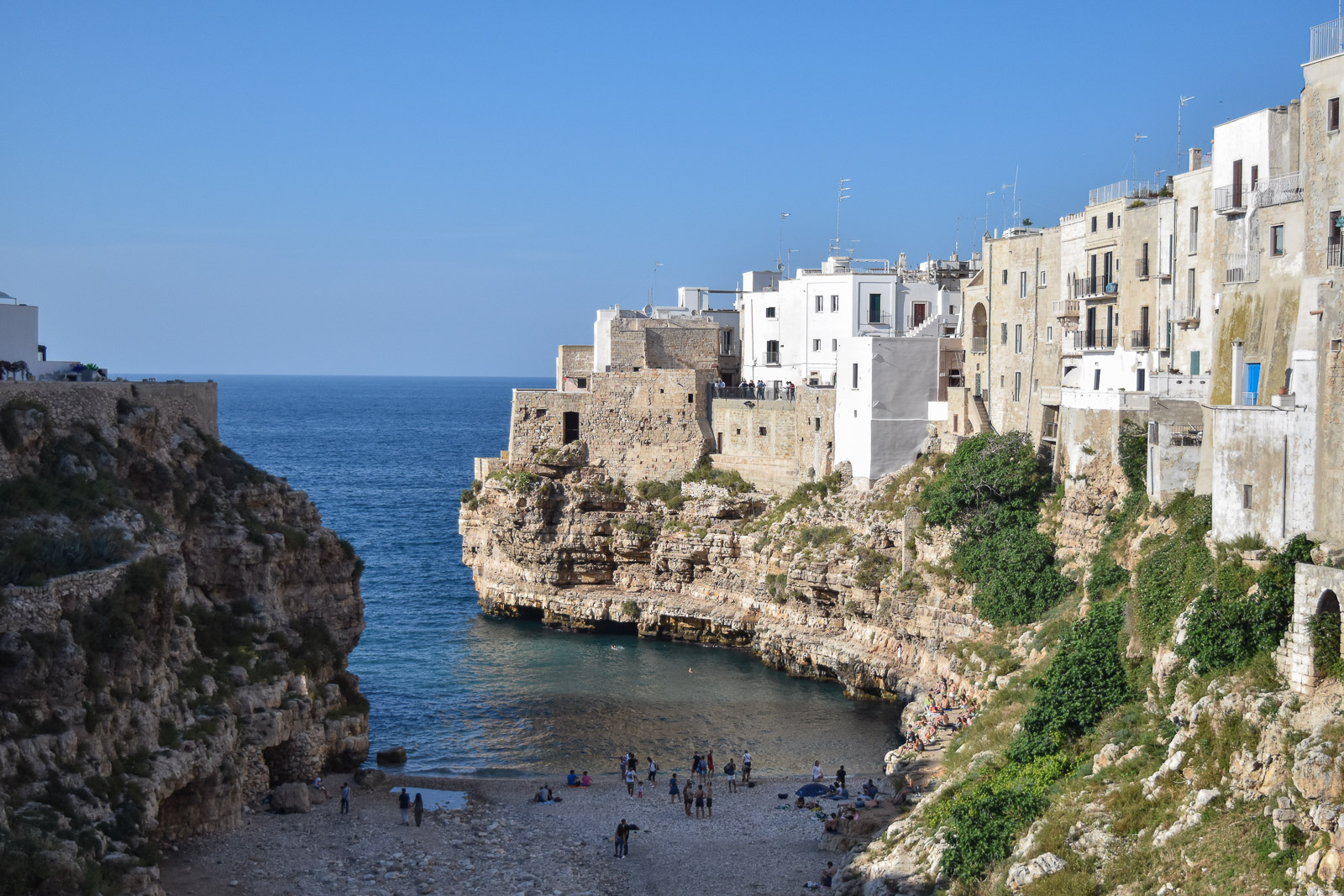 White houses on the cliff side overlooking the beach at polignano a Mare