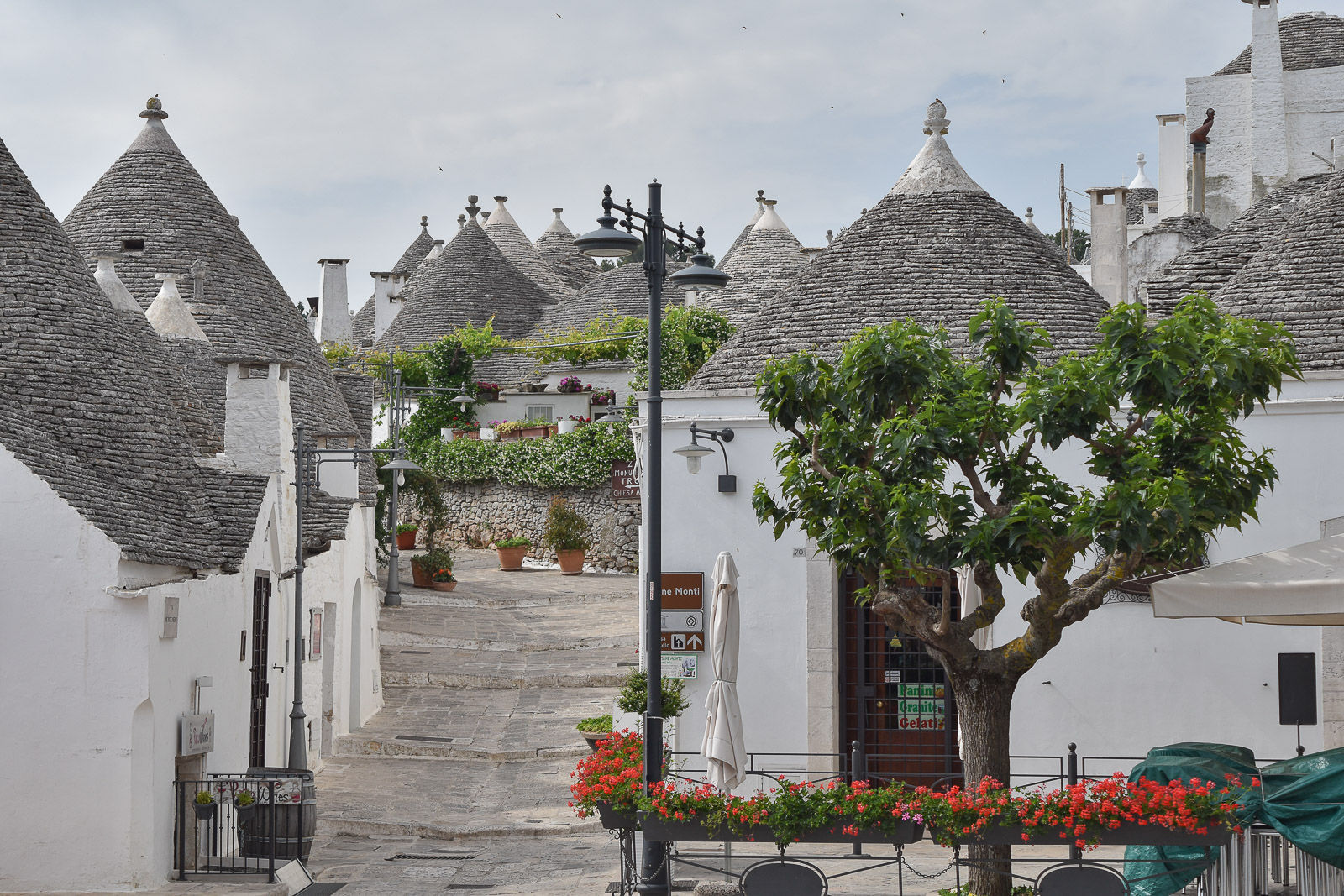 A street full of buildings with conical shaped roofs in Alberobello, Puglia