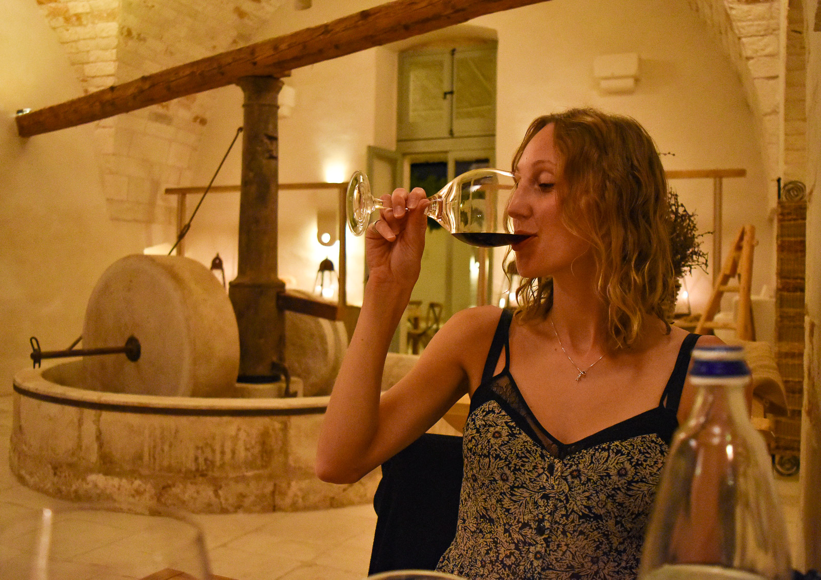 Hayley drinking a glass of negroamaro - one of the best things to do in Puglia 