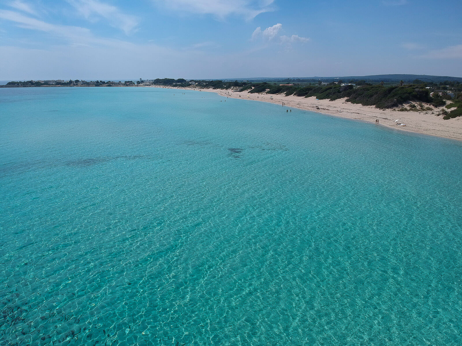 A long sandy beach with crystal clear water 