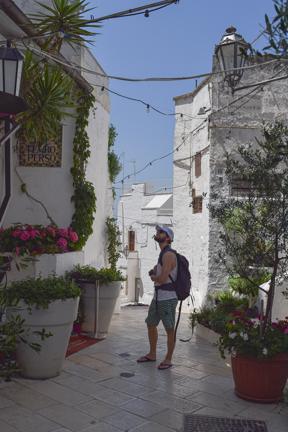 Enrico admiring the coloruful flowers in the lanes of Ostuni