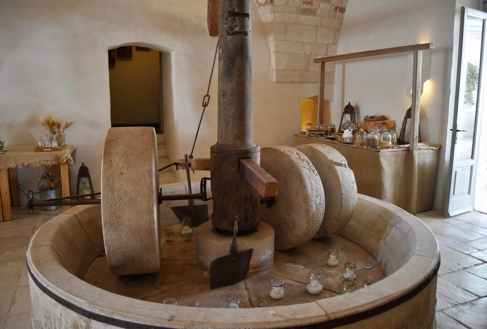 An olive press decorated with candles