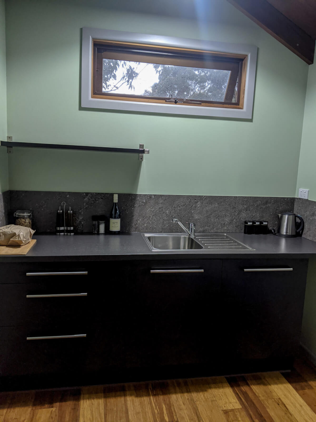 A kitchen with a fresh loaf of bread on the side