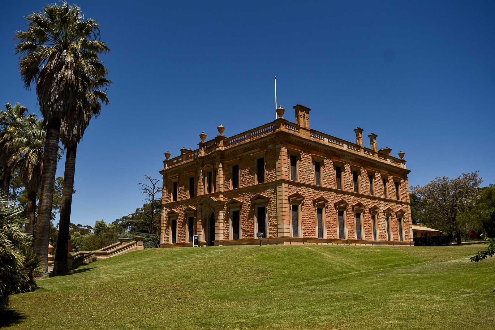 A grand mansion surrounded by gardens 