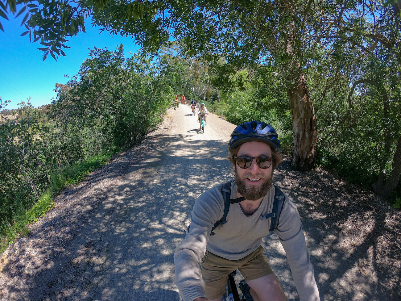 Enrico cycling the trail with Hayley and friends behind