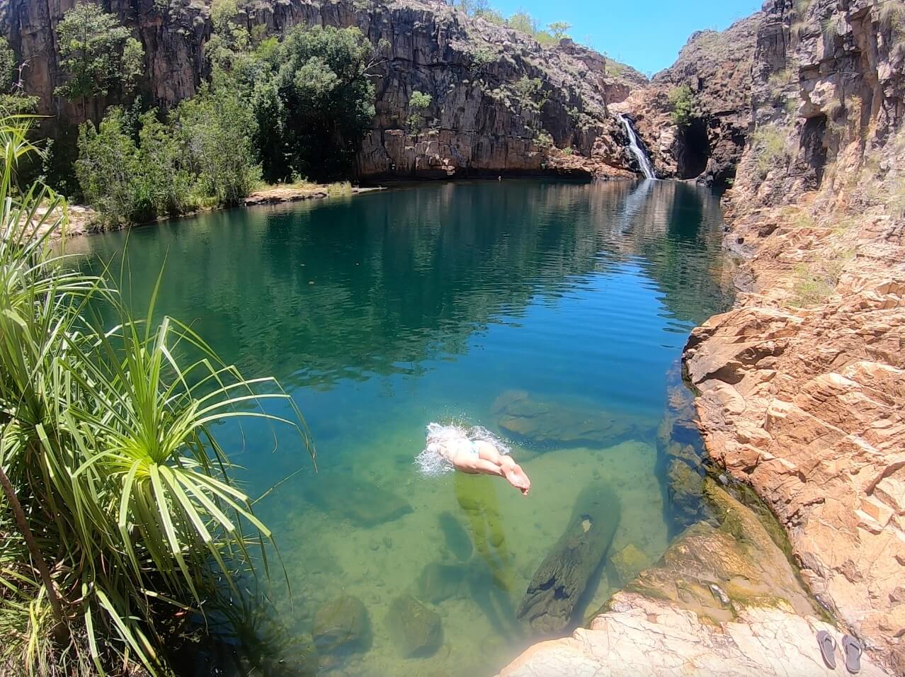 Hayley dives off a rock into the water at Maguk