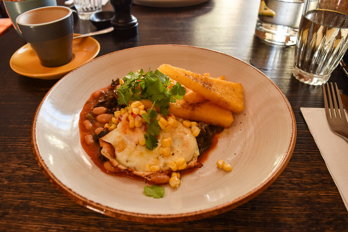 A plate of southern style eggs, fried polenta and beans at Stillwater