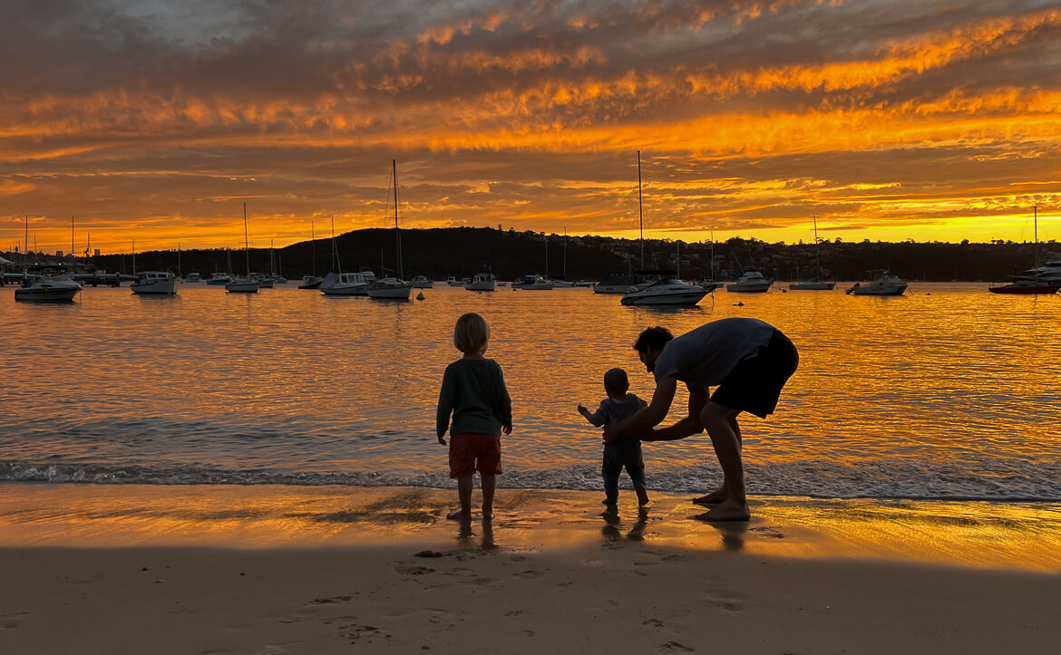 A family on the beach at sunset