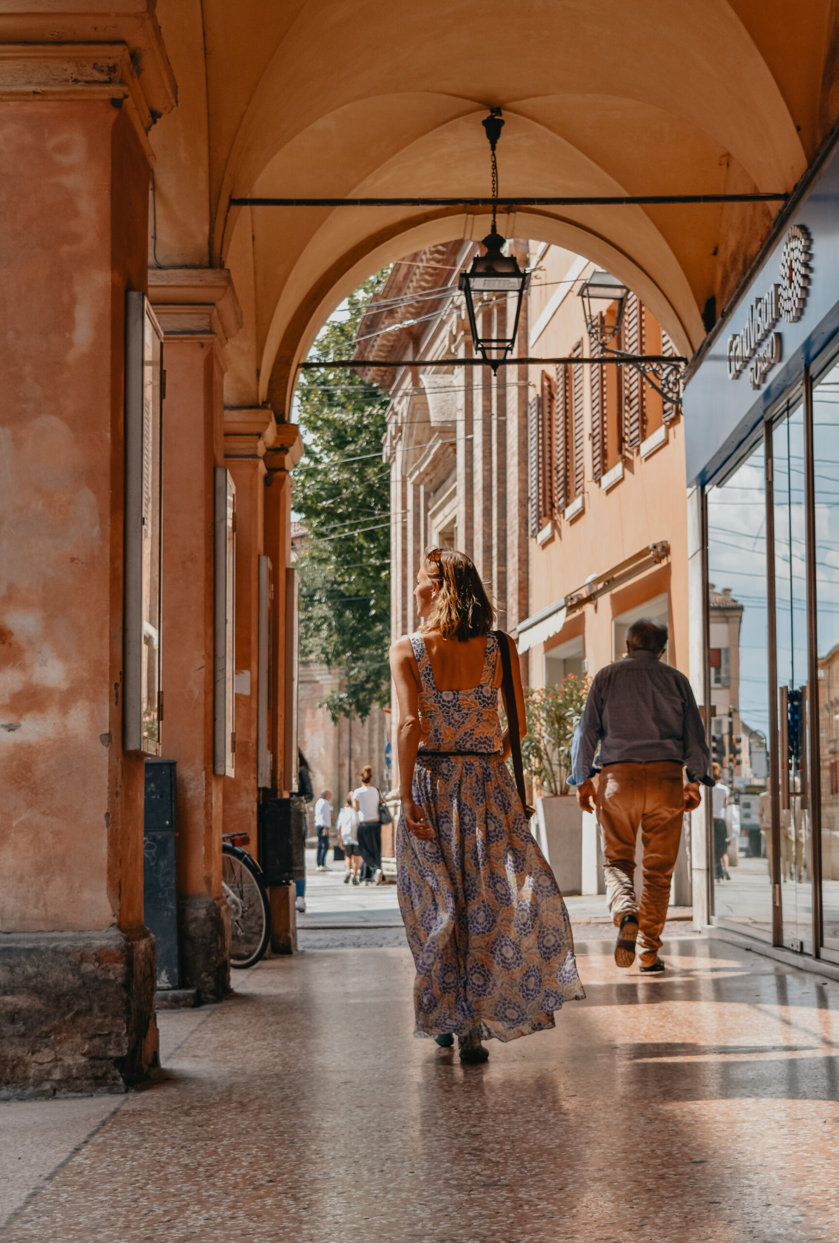 A woman wandering through the porticos of Modena