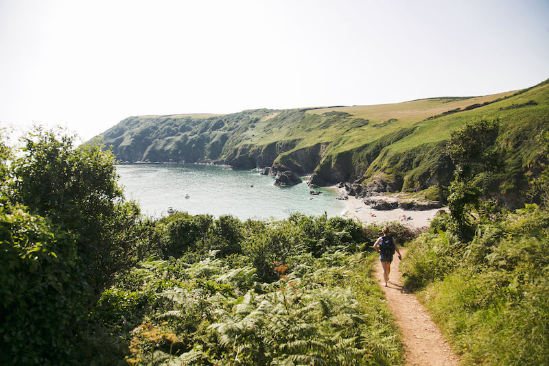 A hiker on a coastal path in Cornwall 
