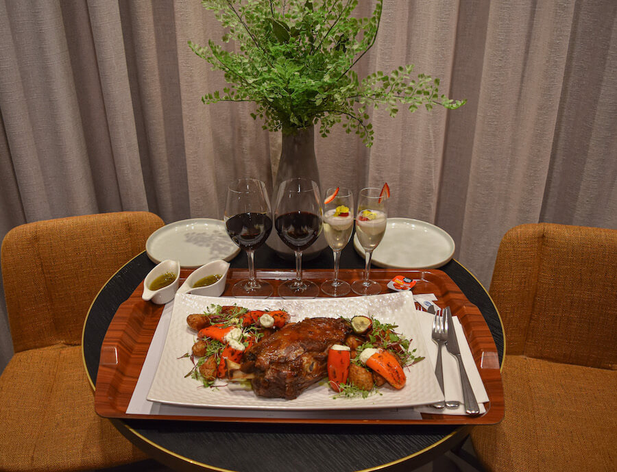 lamb shoulder served with cheese filled peppers and red wine