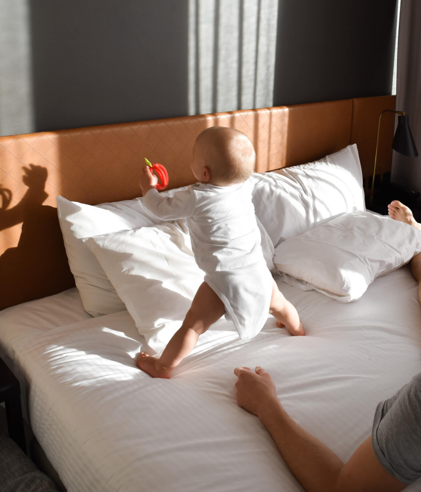 A baby on the bed at Vibe Hotel Canberra