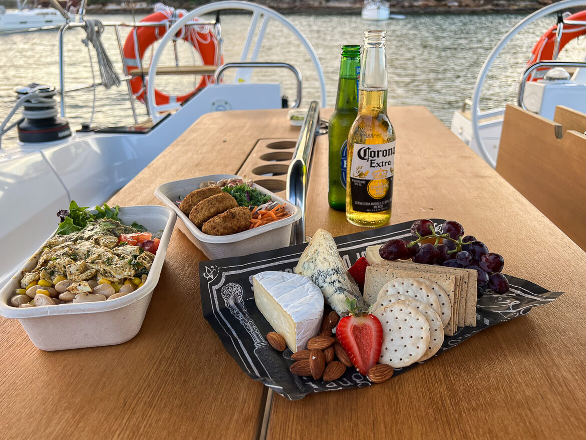 A cheese platter and salads on the deck of a yacht in Sydney