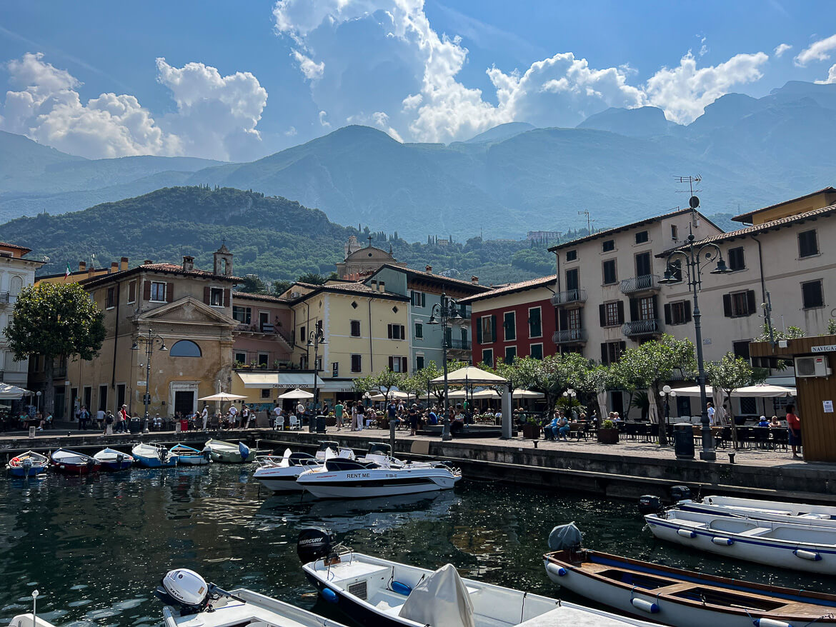 Boats in Malcesine Marine, with mountains in the background.