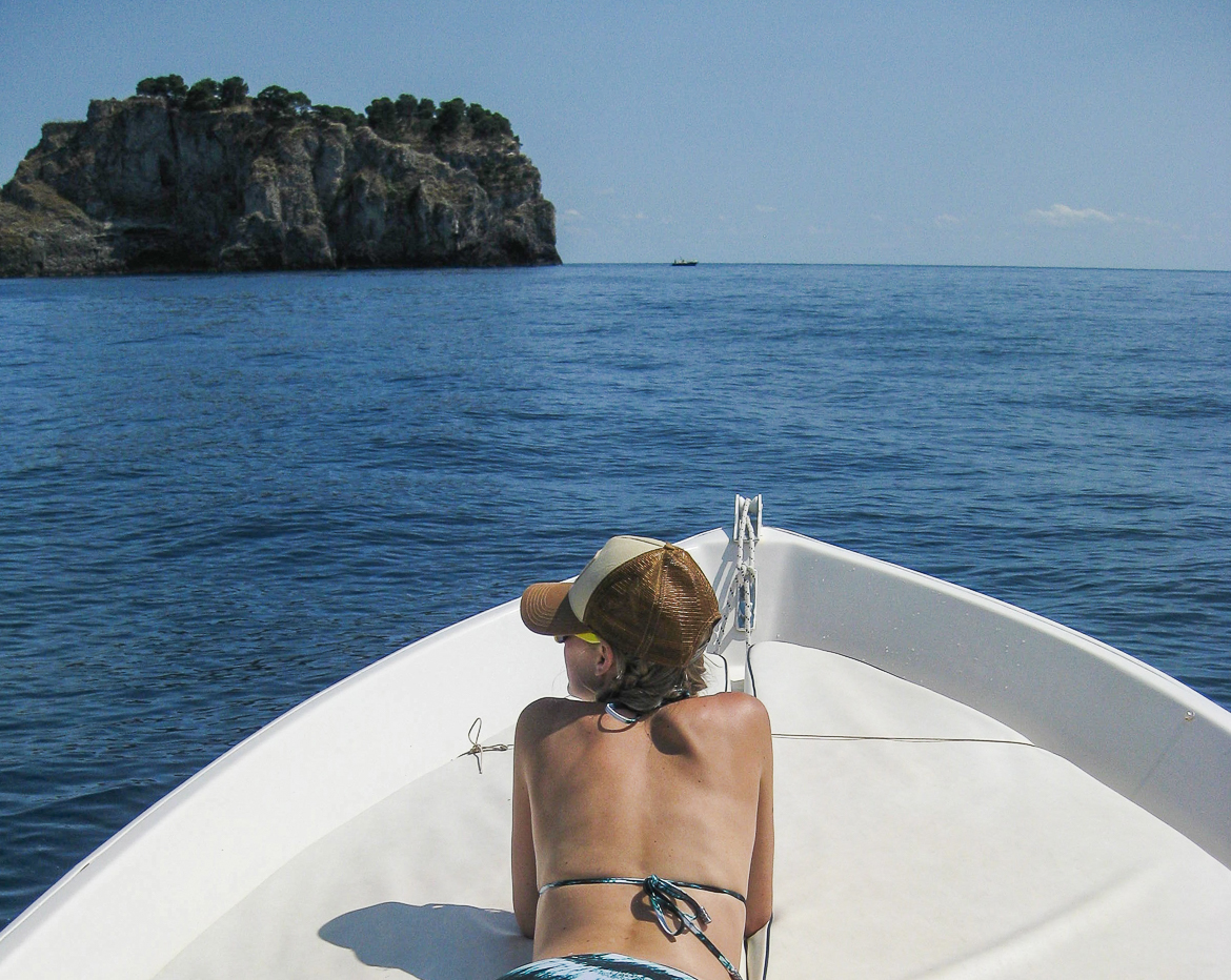 A woman relaxing on a boat on the Amalfi Coast