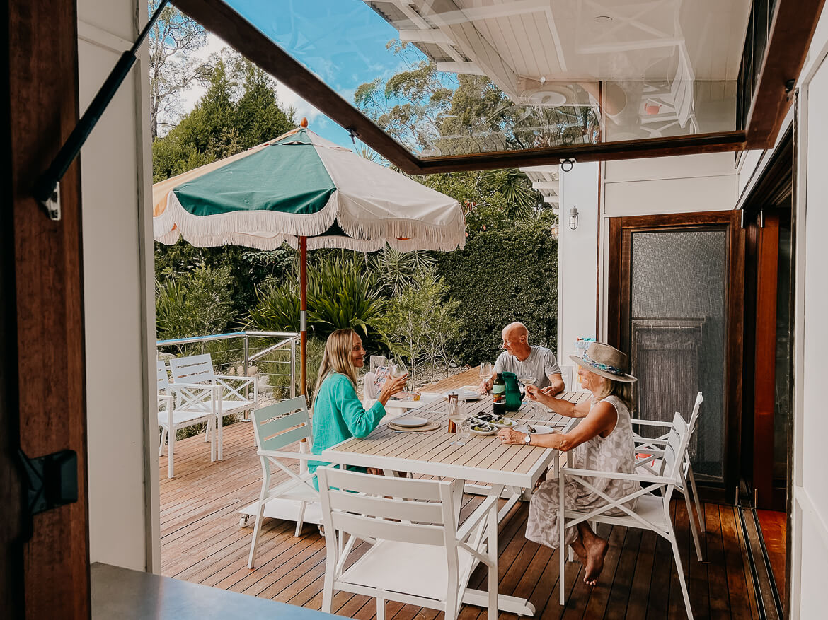 A family enjoying lunch together on a terrace in Jervis Bay