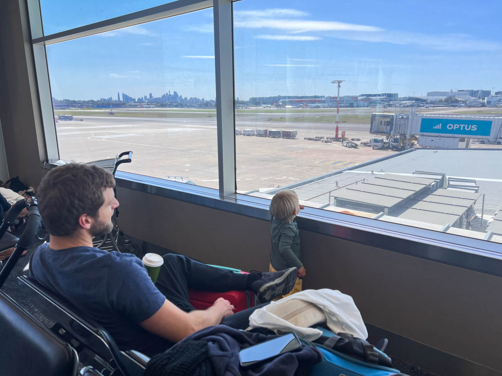 A dad and toddler watching the planes at Sydney airport