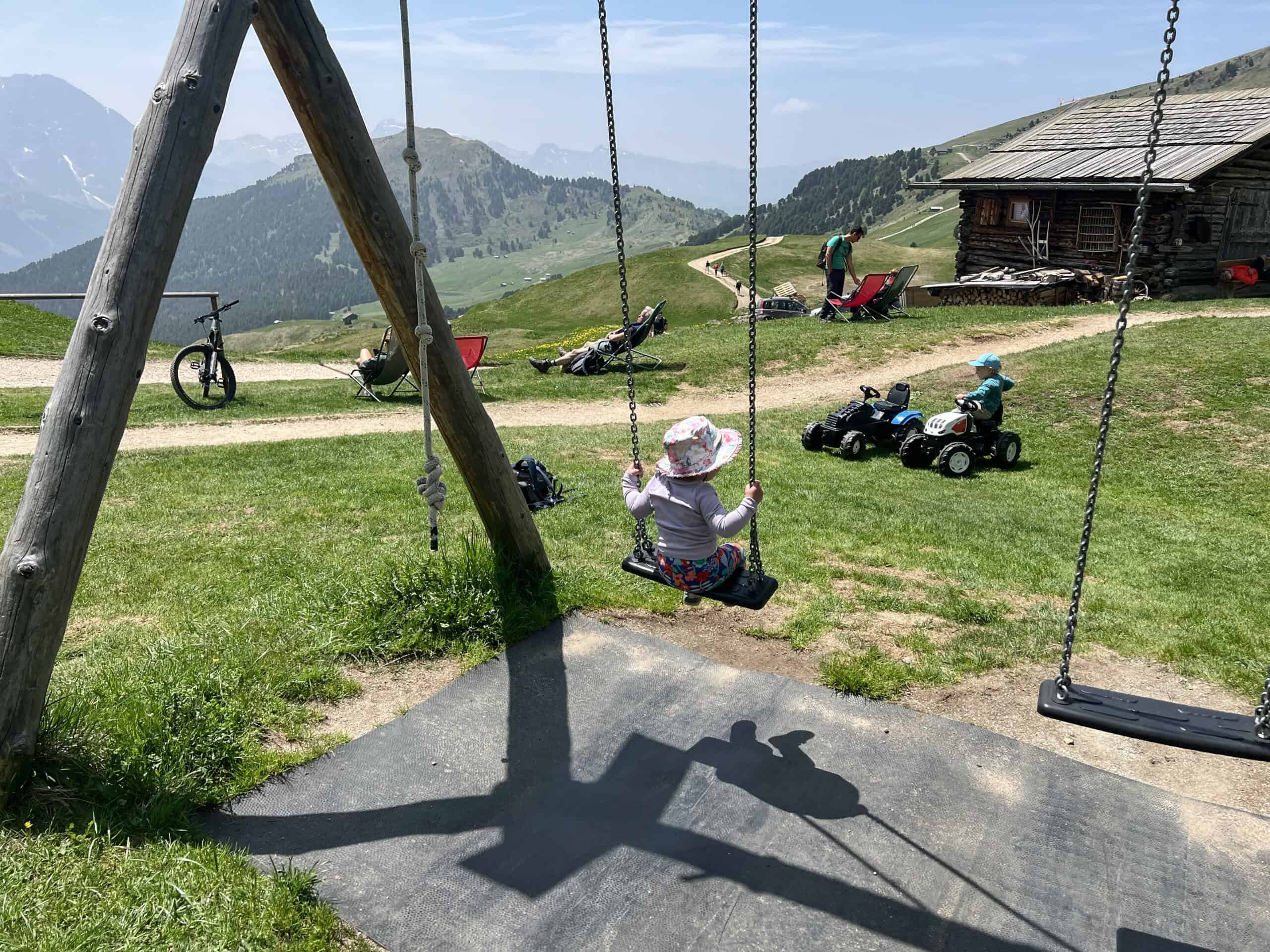 Swings and tractors at a mountain playground